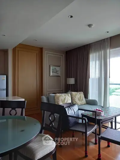 Spacious living room with elegant decor and natural light in modern apartment.