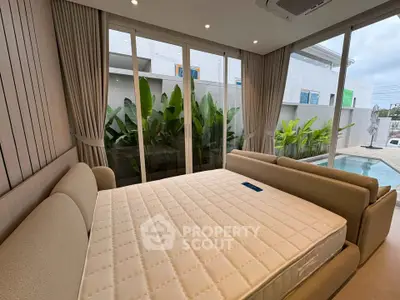 Luxurious bedroom with pool view and elegant decor in modern home