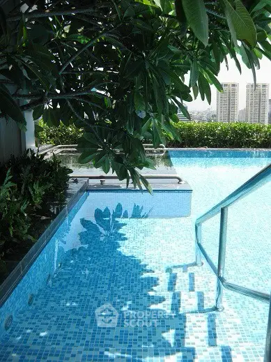Luxurious rooftop pool with stunning city views and lush greenery
