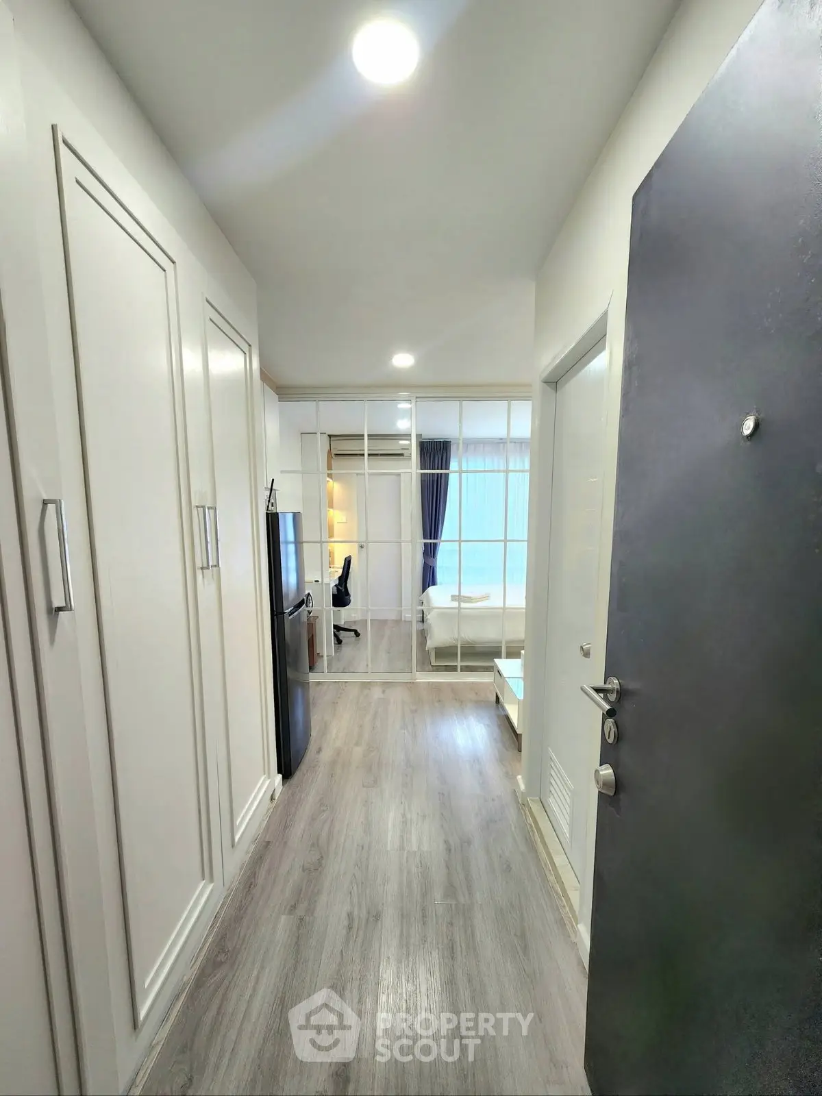 Modern apartment entrance with sleek design and bright interior lighting