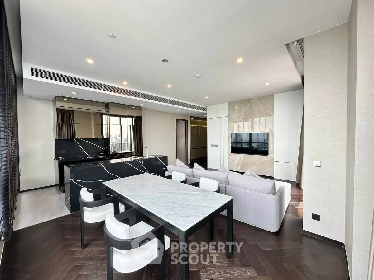 Luxurious modern living room with open kitchen and elegant dining area
