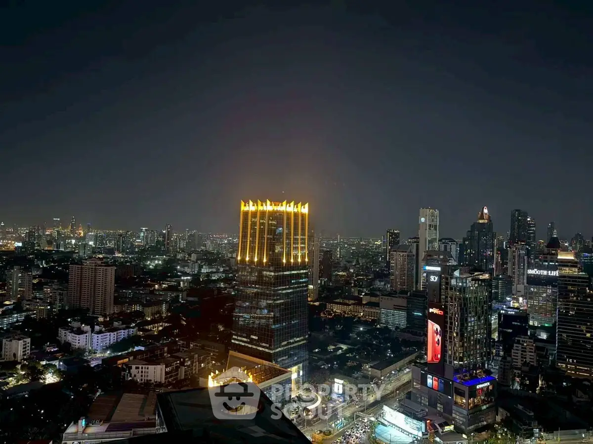Stunning cityscape view with illuminated skyscrapers at night, showcasing vibrant urban living.