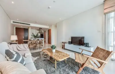 Spacious modern living room with stylish furniture and open kitchen layout