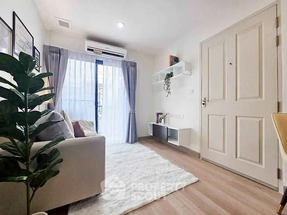 Bright and cozy living room with modern decor and large window view.