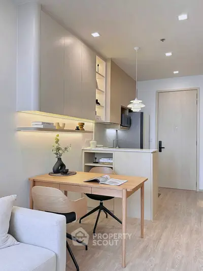 Modern open-plan kitchen and dining area with sleek design and warm lighting.
