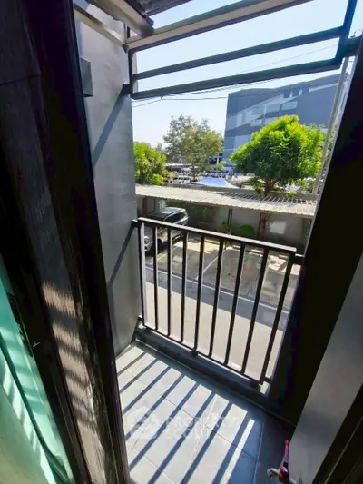 Charming small balcony with street view, perfect for urban living.