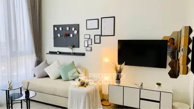 Modern living room with stylish decor, wall-mounted TV, and cozy seating area.