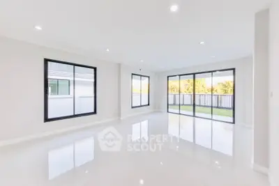 Spacious modern living room with large windows and garden view