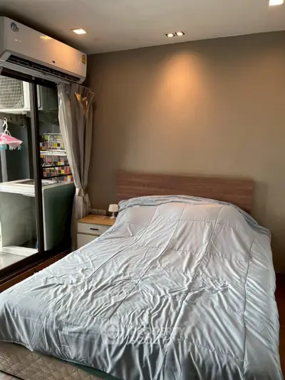 Cozy bedroom with modern air conditioning and balcony access