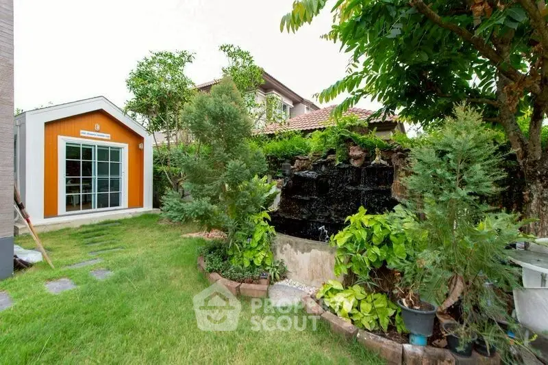 Charming garden with lush greenery and a cozy shed, perfect for relaxation and outdoor activities.
