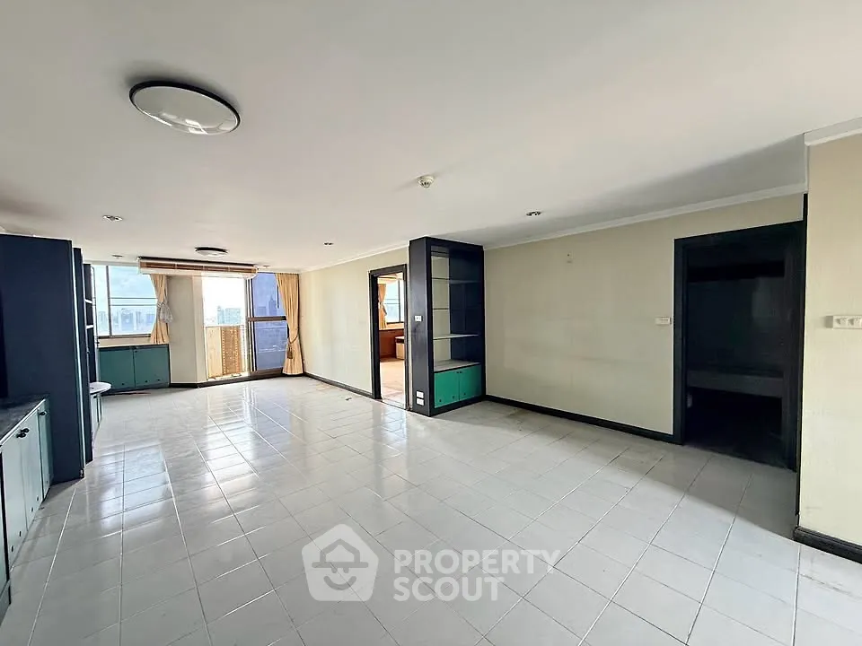 Spacious living room with large windows and balcony access in modern apartment