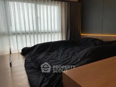 Modern bedroom with large window and sleek design