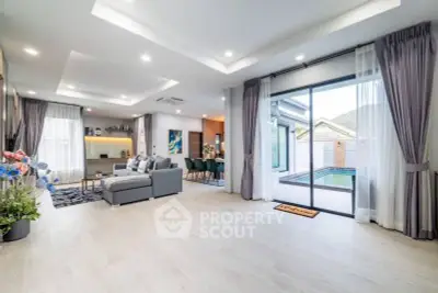 Spacious modern living room with pool view and elegant decor