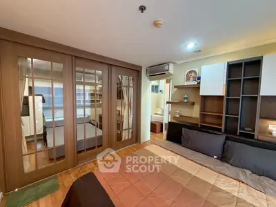 Spacious bedroom with mirrored closet and modern decor