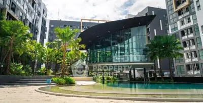 Luxurious modern apartment complex with stunning pool and lush greenery