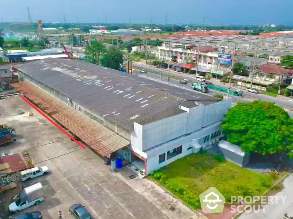 Expansive industrial warehouse with spacious parking and strategic location.