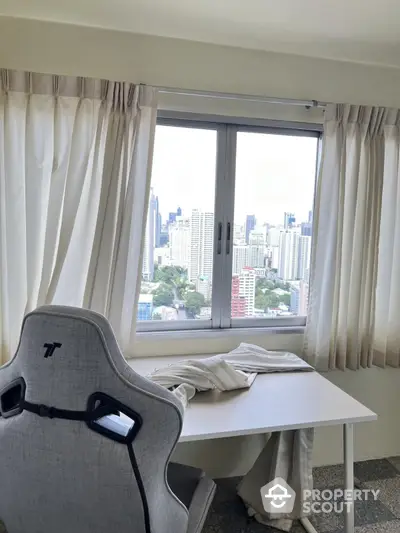 Modern study room with city view from high-rise apartment window