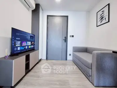 Modern living room with sleek furniture and smart TV, perfect for urban living.