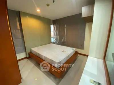 Modern bedroom with sleek design and large windows in a stylish apartment.