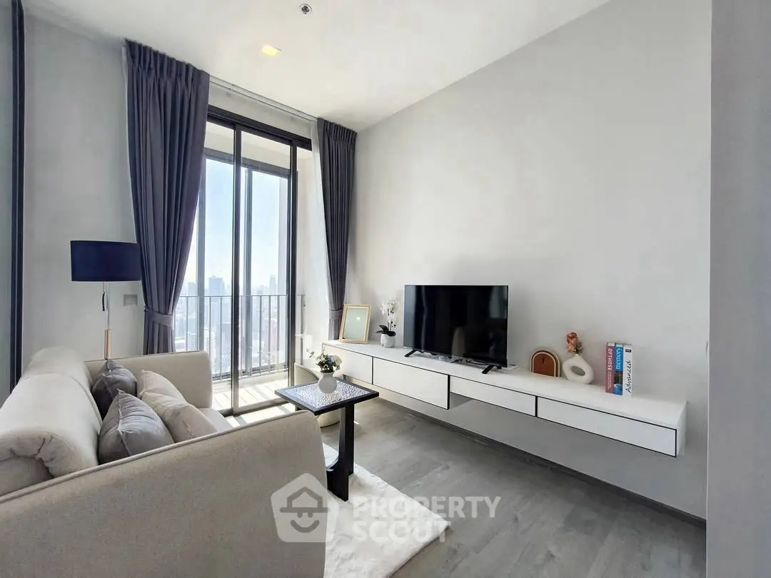 Modern living room with sleek furniture and city view balcony.