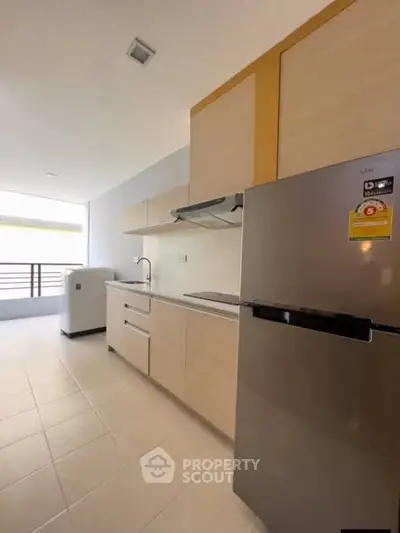 Modern kitchen with sleek cabinetry and stainless steel appliances in a bright, open layout.
