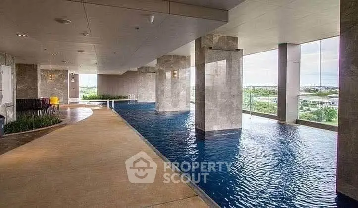 Luxurious indoor pool with panoramic views in modern high-rise building