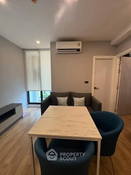 Modern living room with cozy seating and air conditioning