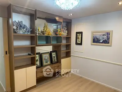 Elegant living room with built-in shelves and framed artwork, perfect for stylish home decor.
