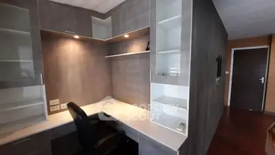 Modern study room with built-in desk and shelves, perfect for productivity.