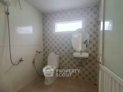 Modern bathroom with elegant tile design and sleek fixtures.