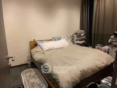 Cozy bedroom with double bed and minimalist decor, perfect for restful nights.