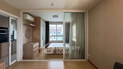 Modern studio apartment with sliding glass partition and natural light