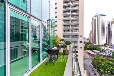 Modern apartment balcony with artificial grass and city view