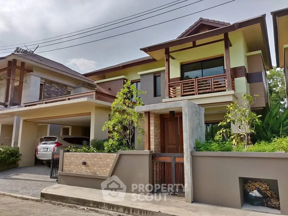 Stunning modern two-story house with lush greenery and spacious carport in a serene neighborhood.