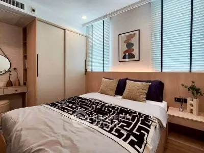 Modern bedroom with stylish decor and ample natural light