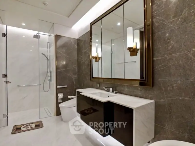 Luxurious modern bathroom with elegant marble walls and sleek fixtures.