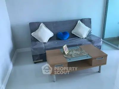 Modern living room with cozy sofa and stylish coffee table in bright apartment.