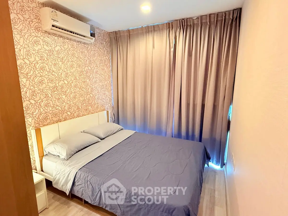 Cozy bedroom with floral wallpaper and elegant curtains in modern apartment.