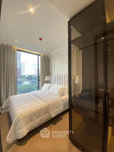 Modern bedroom with large window and elegant decor in a high-rise apartment.