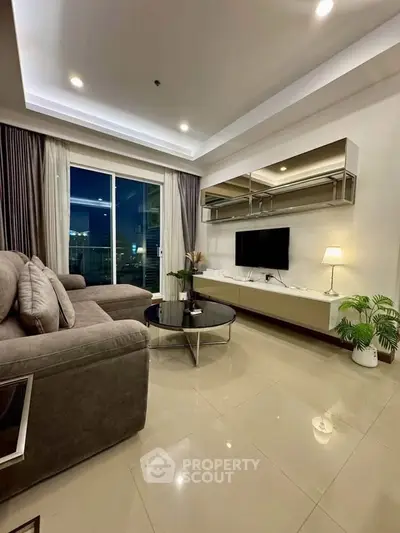 Modern living room with sleek furniture and large window offering city view