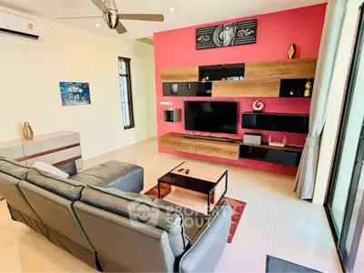 Modern living room with stylish furniture and entertainment center, featuring a vibrant accent wall and sleek decor.