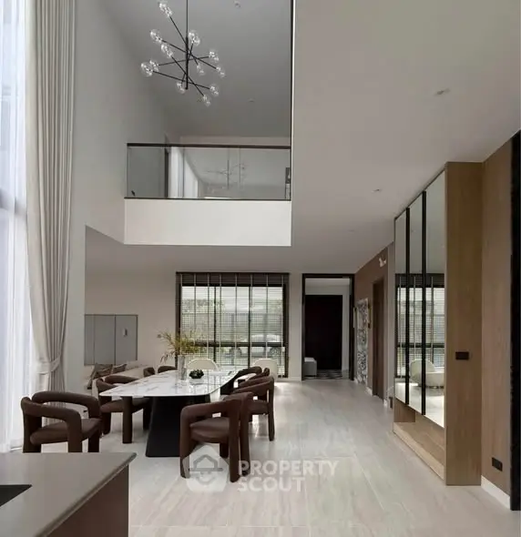 Luxurious modern living room with high ceilings and elegant dining area