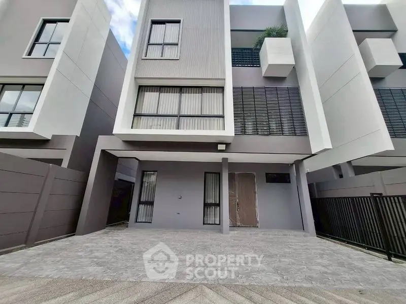 Modern townhouse exterior with sleek design and spacious driveway
