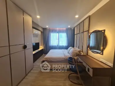 Spacious modern bedroom with elegant decor and ample natural light