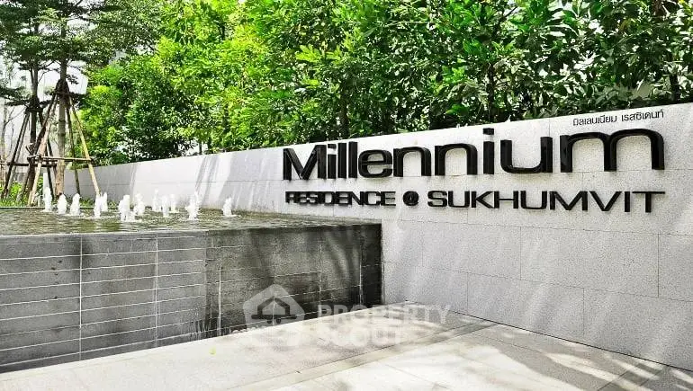 Luxurious Millennium Residence entrance with modern design and lush greenery in Sukhumvit.