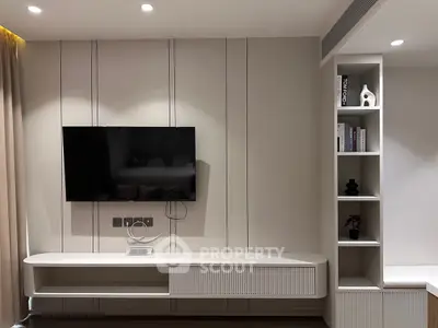 Modern living room with sleek TV unit and built-in shelving, perfect for stylish urban living.