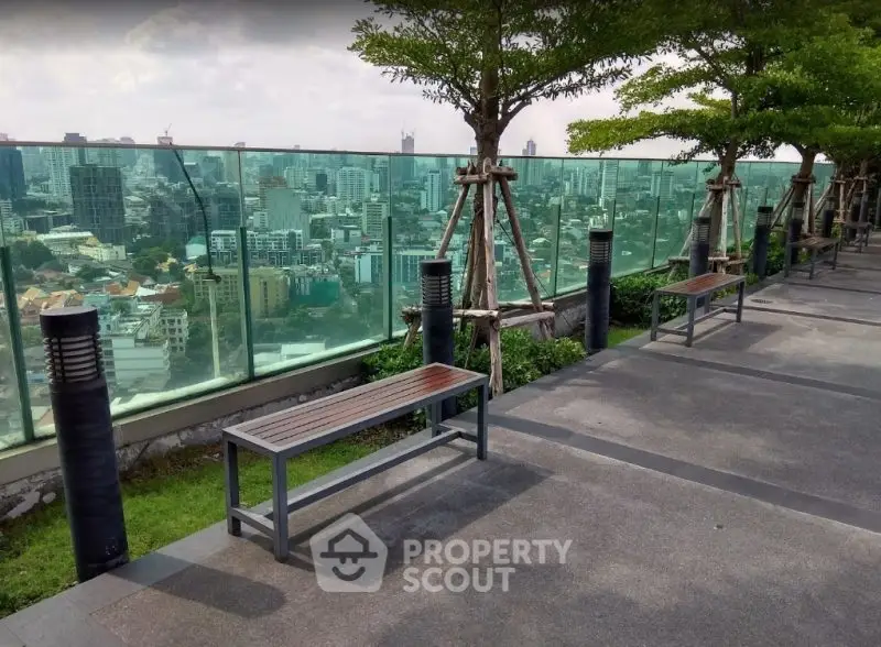 Stunning rooftop view with benches overlooking city skyline