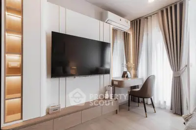 Modern living room with sleek TV setup and elegant curtains