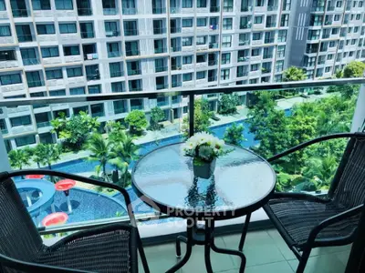 Charming balcony with pool view in modern apartment complex