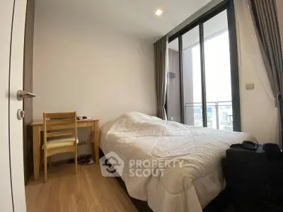 Cozy bedroom with balcony view in modern apartment